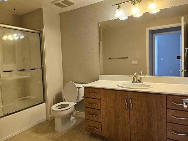 full bathroom featuring shower / bath combination with glass door, vanity, toilet, and tile patterned flooring