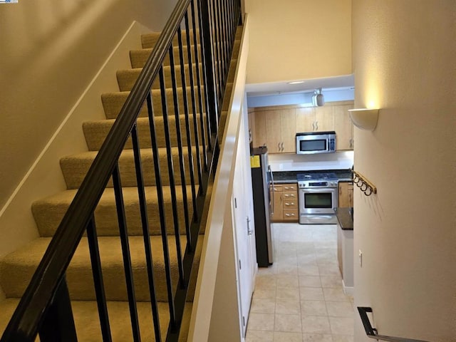 staircase featuring tile patterned floors