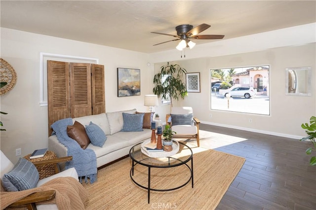 living room with ceiling fan and dark hardwood / wood-style floors