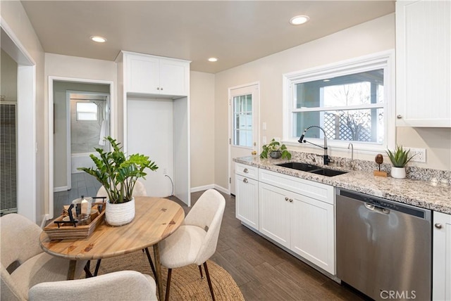 kitchen with white cabinetry, stainless steel dishwasher, light stone counters, and sink