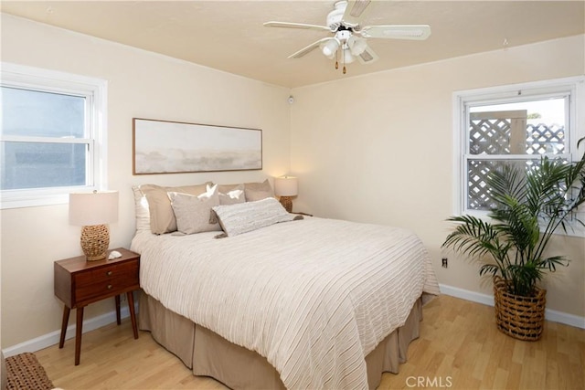 bedroom with ceiling fan and light hardwood / wood-style flooring