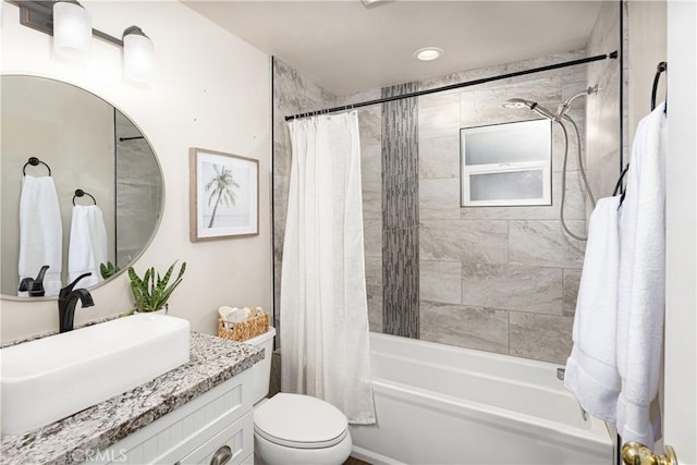 full bathroom featuring toilet, shower / bath combo, and vanity