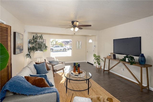 living room with ceiling fan and dark wood-type flooring