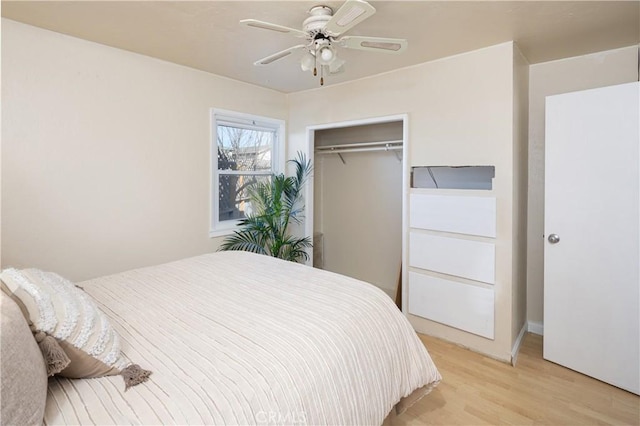 bedroom featuring ceiling fan, light hardwood / wood-style floors, and a closet