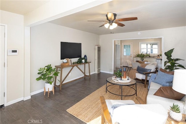 living room with ceiling fan, sink, and dark hardwood / wood-style flooring