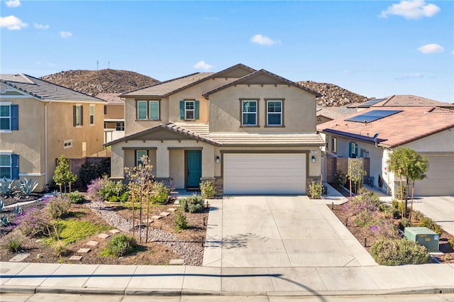 front of property featuring a mountain view and a garage