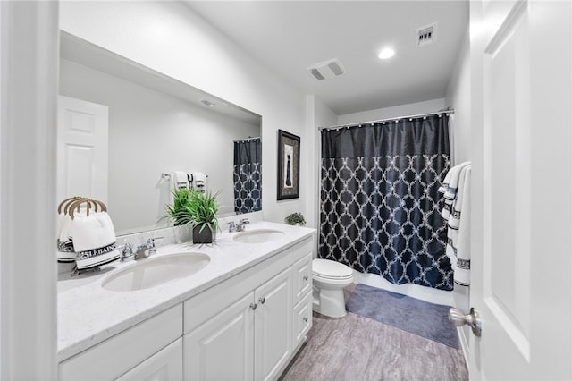 bathroom featuring walk in shower, vanity, and toilet