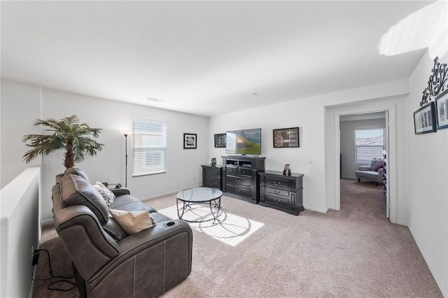 living room featuring a healthy amount of sunlight and light colored carpet