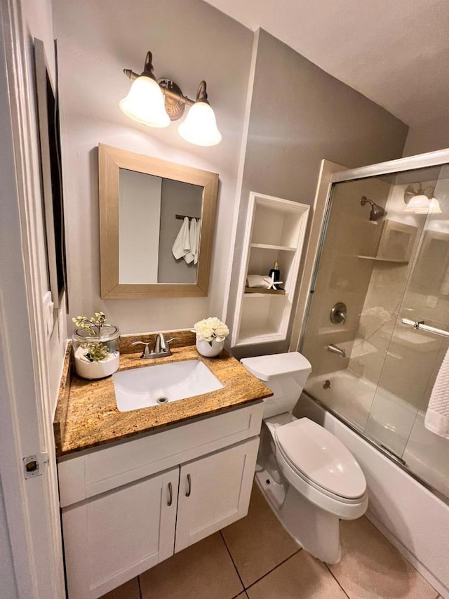 full bathroom with toilet, vanity, tile patterned floors, and shower / bath combination with glass door