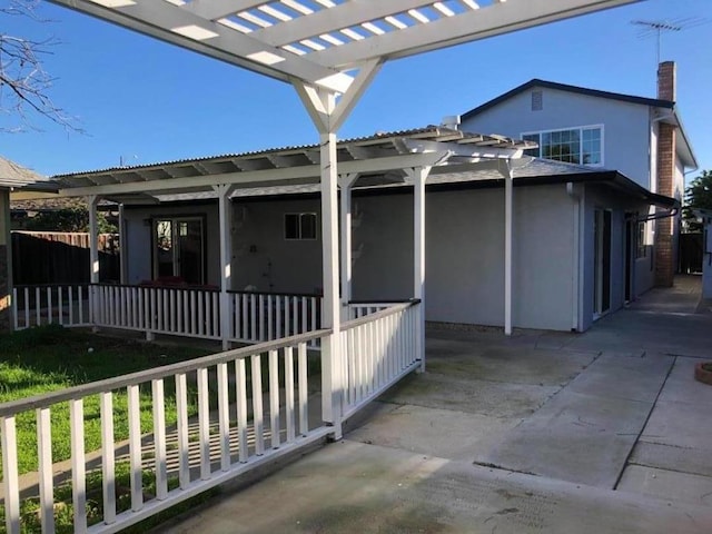 back of house featuring a pergola and a patio area