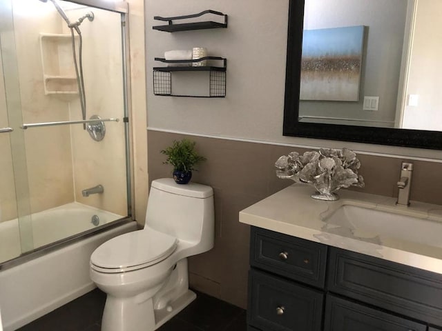 full bathroom featuring toilet, vanity, and shower / bath combination with glass door