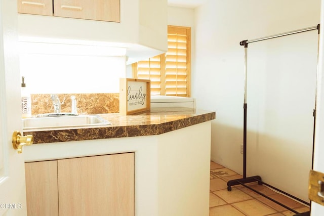 interior space with light brown cabinets and sink