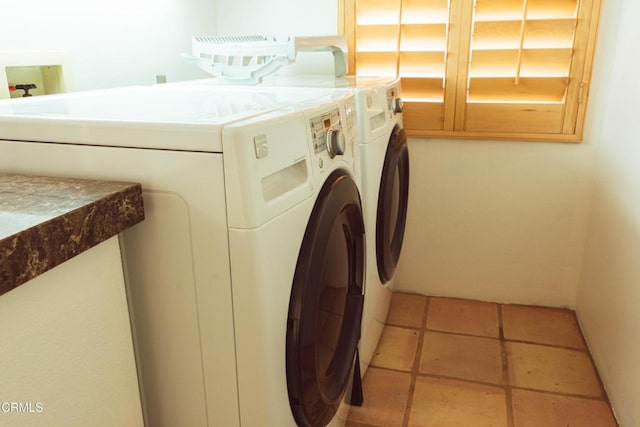 laundry room with tile patterned floors and washer and clothes dryer