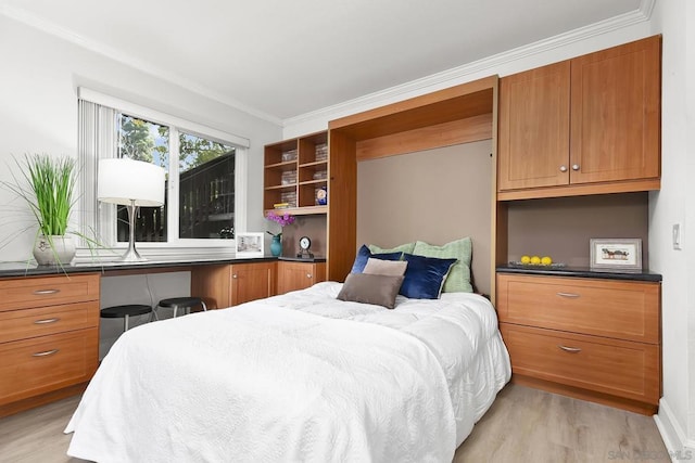 bedroom with crown molding and light hardwood / wood-style floors