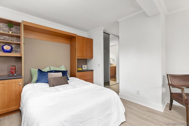 bedroom with ornamental molding and light wood-type flooring