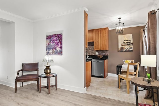 kitchen featuring an inviting chandelier, hanging light fixtures, ornamental molding, decorative backsplash, and stainless steel dishwasher