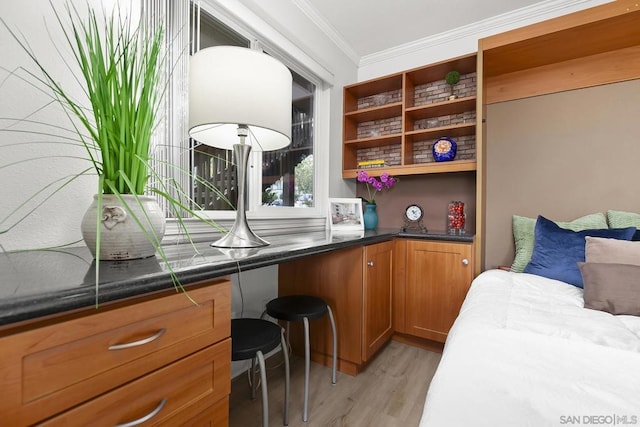 bedroom featuring ornamental molding and light hardwood / wood-style floors