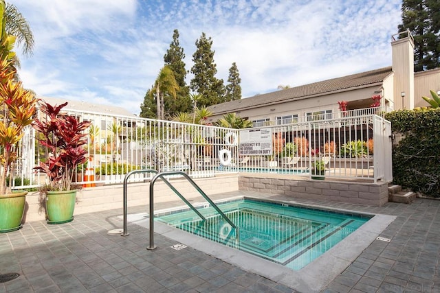 view of pool with a community hot tub