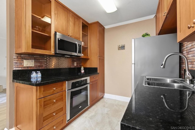 kitchen featuring stainless steel appliances, sink, dark stone countertops, and decorative backsplash