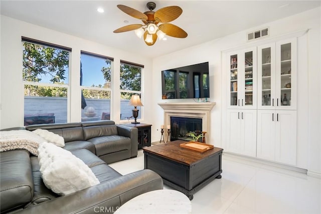 living room with ceiling fan and light tile patterned floors