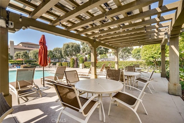 view of patio / terrace featuring a community pool and a pergola