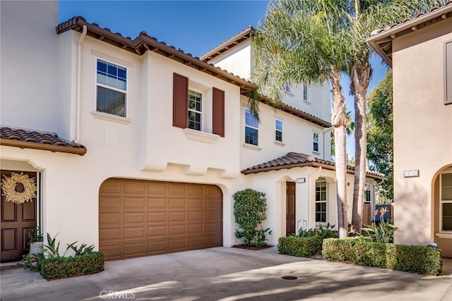 mediterranean / spanish-style house with a garage