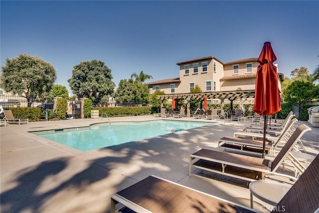 view of swimming pool featuring a patio area and a pergola