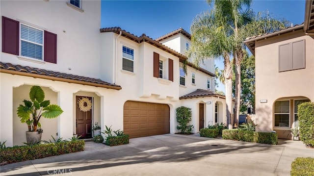 mediterranean / spanish house featuring a garage