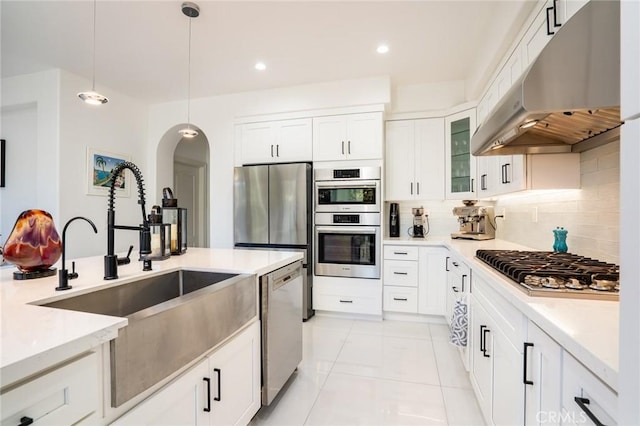 kitchen featuring sink, white cabinetry, hanging light fixtures, and appliances with stainless steel finishes