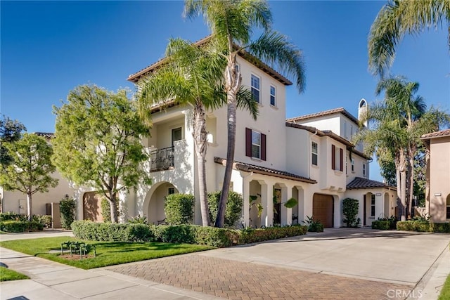 view of front of house featuring a balcony and a garage