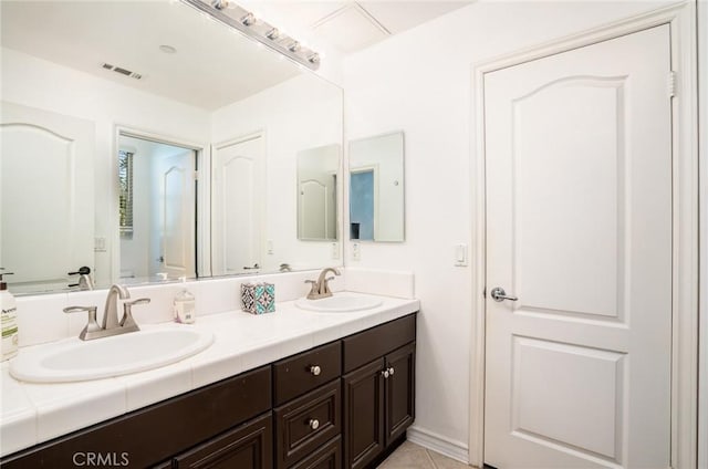 bathroom featuring tile patterned flooring and vanity