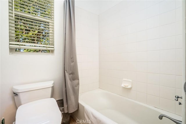 bathroom with shower / tub combo with curtain and toilet