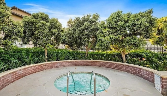 view of pool with an in ground hot tub