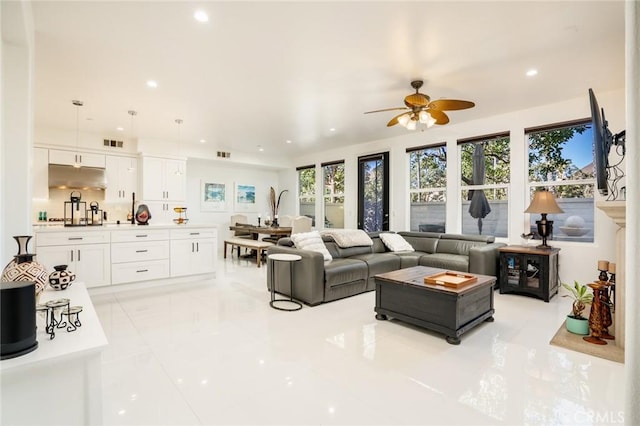 tiled living room with ceiling fan