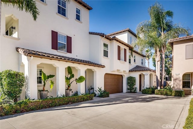 mediterranean / spanish-style house with a garage