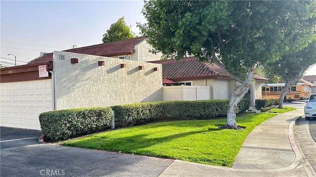 view of front of house with a front yard and a garage