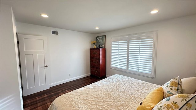 bedroom with dark hardwood / wood-style floors