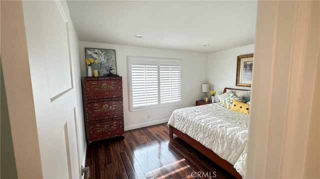 bedroom with dark hardwood / wood-style flooring