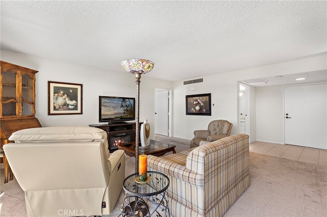 living room featuring light colored carpet, a textured ceiling, and a fireplace