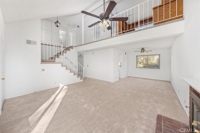 unfurnished living room featuring light carpet, high vaulted ceiling, and ceiling fan