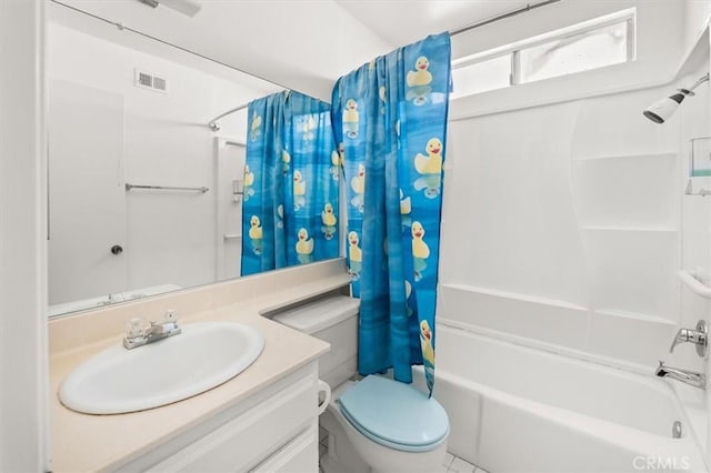 full bathroom featuring tile patterned floors, vanity, shower / bath combination with curtain, and toilet