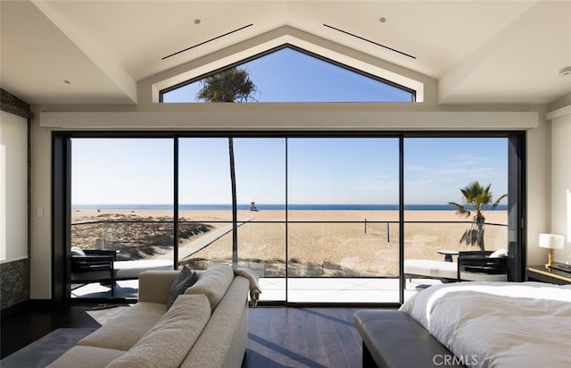 bedroom with hardwood / wood-style flooring, lofted ceiling, and a water view