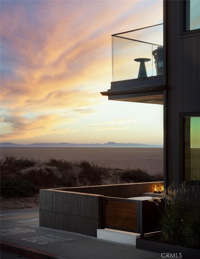 patio terrace at dusk featuring a mountain view