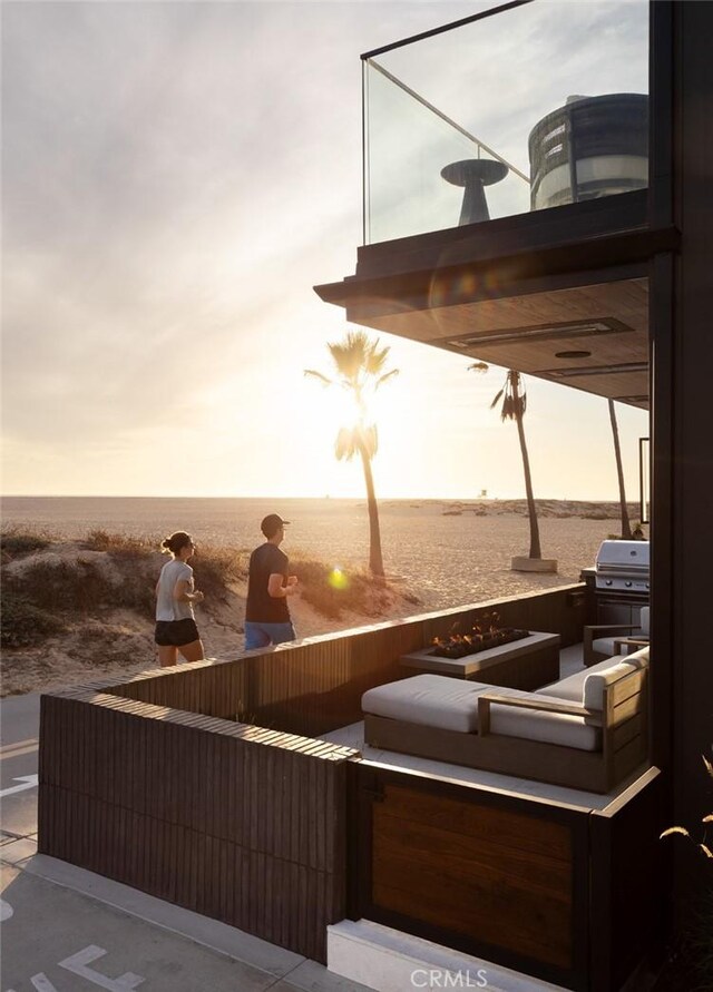 patio terrace at dusk featuring a water view