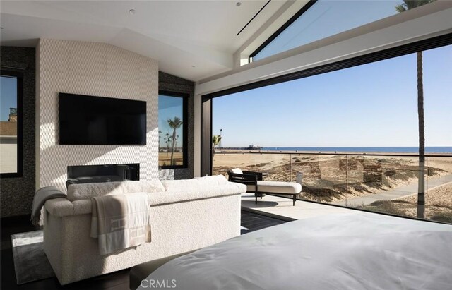 bedroom with a water view and vaulted ceiling