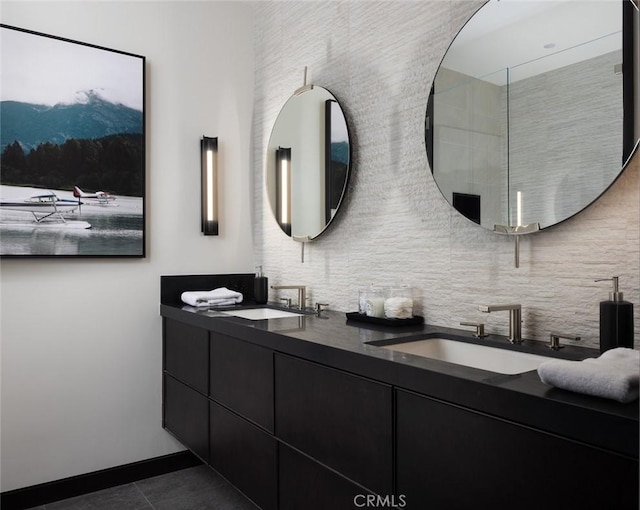 bathroom featuring tile patterned flooring, tasteful backsplash, and vanity