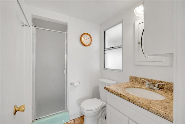 bathroom with walk in shower, vanity, toilet, and hardwood / wood-style flooring