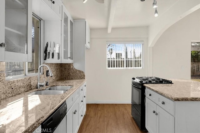 kitchen featuring stainless steel dishwasher, gas stove, white cabinets, and sink