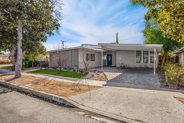 ranch-style house featuring a carport