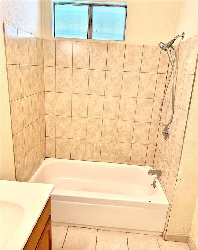 bathroom featuring vanity, tile patterned flooring, and tiled shower / bath